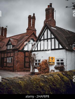 Rue de la maison Tudor avec vue sur une église fortifiée dans Great Budworth.Great Budworth est un village et une paroisse civile à Cheshire, en Angleterre. Banque D'Images