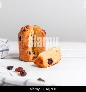 Mini-panettone de noël traditionnel avec raisins secs et fruits secs sur table blanche Banque D'Images