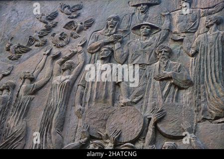 La frise en bronze œuvre socialiste au métro Mustakillik Maydoni, entrée du métro.Les femmes libérant des oiseaux.À Tachkent, Ouzbékistan. Banque D'Images