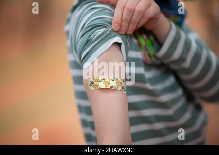 15 décembre 2021, Basse-Saxe, Lüneburg: Matilda (8) montre son plâtre sur son bras après sa vaccination contre le virus Corona dans le centre mobile de vaccination des enfants.En Basse-Saxe, la vaccination de Corona pour les enfants de cinq à onze ans a commencé.Photo: Daniel Reinhardt/dpa Banque D'Images