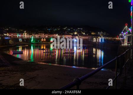 Mousehole,Cornouailles,15th décembre 2021, les gens visitent Mousehole pour voir les célèbres lumières de Noël dans les Cornouailles.À marée haute, les réflexions de lumière s'écouteront à travers le port.Il y a toutes les lumières traditionnelles de fête, y compris un chat et la souris.Credit: Keith Larby/Alamy Live News Banque D'Images