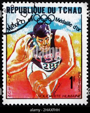 TCHAD - VERS 1969 : un timbre imprimé au Tchad montre Randy Matson, Shot Put, Athlétisme, vainqueur des Jeux Olympiques de 1968, Mexique, vers 1969 Banque D'Images