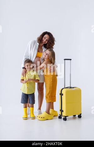 Bonne femme enceinte embrassant ses adorables enfants Banque D'Images
