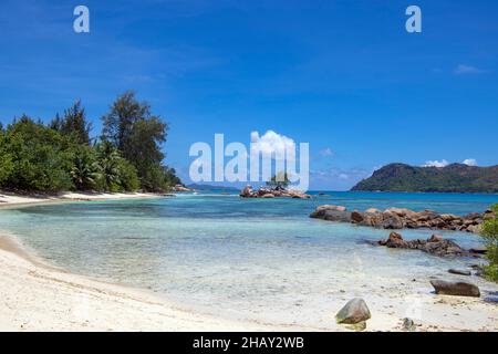 Côte rocheuse avec petite baie et île Anse Takamaka Praslin Island Seychelles Banque D'Images