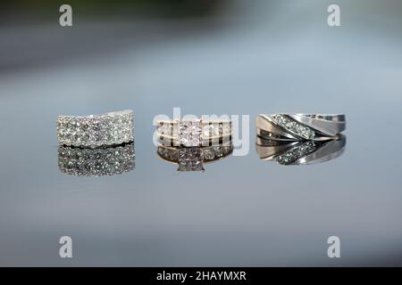 anneaux de mariage en or blanc avec diamants côte à côte et serface réfléchissante en verre Banque D'Images