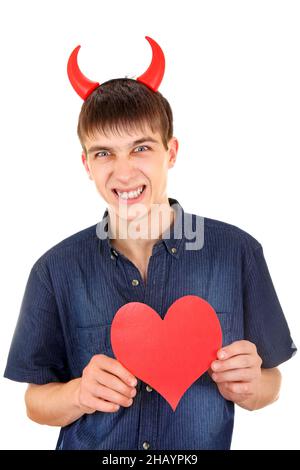 Adolescent en colère avec des cornes de diable et la forme de coeur rouge isolée sur le fond blanc Banque D'Images