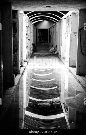 Vue verticale en niveaux de gris du couloir dans le bâtiment abandonné.Mexico. Banque D'Images