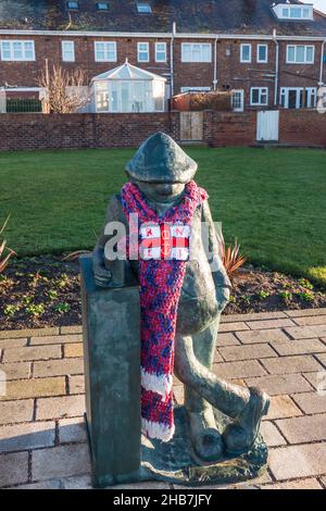Statue d'Andy CAPP, un célèbre personnage de dessin animé créé par Reg Smythe et présenté dans le journal Daily Mirror pendant de nombreuses années.Port d'une écharpe RNLI Banque D'Images
