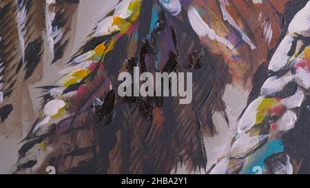 Un artiste designer dessine un aigle sur le mur.Artisan décorateur peint une image avec de l'huile acrylique couleur.Gros plan, magie et obscurité, aspect cinématographique. Banque D'Images