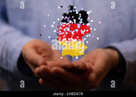 Un rendu en 3D de la carte numérique de l'Allemagne dans les mains d'une personne Banque D'Images