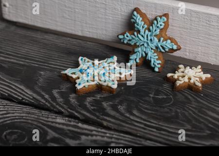 Biscuits au pain d'épice en forme de flocons de neige.Décoration avec glaçage au sucre.Biscuits au pain d'épice en forme de flocons de neige.Couchez-vous sur des tableaux noirs.CLO Banque D'Images