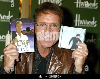 Mike Read, DJ radio de 'Merry Cliffmas', présente le chanteur Sir Cliff Richard, qui rencontre des fans et signe des copies de son dernier album 'Somethin' is Goin' on' et DVD 'Cliff Richard Live - Castles in the Air' à Harrods le 1 décembre 2004 à Londres. Banque D'Images