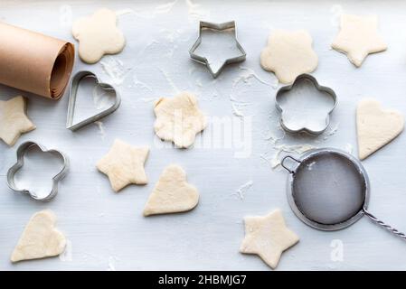 Vue de dessus de la cuisson d'un biscuit de pain d'épice sous forme de coeur, étoile, nuage et fleur.Concept Noël et nouvel an, préparations festives pour l'hiver Banque D'Images