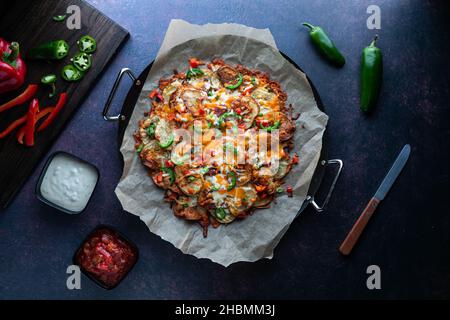 Vue de haut en bas d'un plateau de nachos coupés de cactus chauds fraîchement sortis du four. Banque D'Images