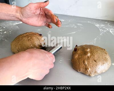 Une femme cuisine pour cuire un pain de seigle Banque D'Images