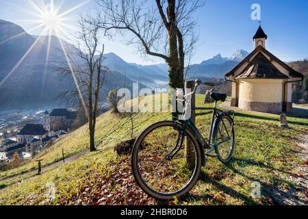 Fahrrad vor der Kirchleitn Kapelle am Mitterweinfeld hoch über Berchtesgaden mit dem maechtigen Watzmann im hintergrund im späten Spätherbstmit tiefs Banque D'Images