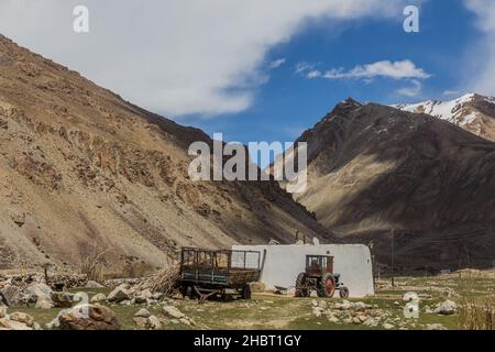 Maison de village et tracteur dans la vallée de la rivière Gunt dans les montagnes de Pamir, Tadjikistan Banque D'Images