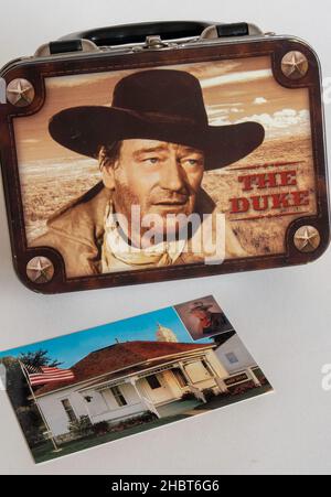 Gros plan d'une boîte à lunch sur le thème John Wayne et d'une carte postale de la place de la naissance, États-Unis Banque D'Images