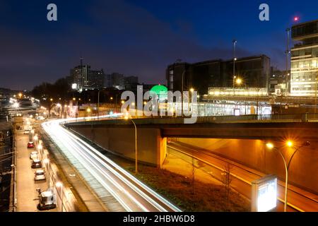 Paris, France.Décembre 18.2021. Vue sur la rue et les bâtiments modernes du centre-ville.Vue sur la ville de Paris la nuit avec phares de voiture. Banque D'Images