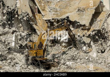 Gaza, Palestine.22nd décembre 2021.Un bulldozer enlève les débris de la tour Al-Jawharah qui a été touchée par les frappes aériennes israéliennes pendant les combats israélo-palestiniens en mai 2021.Crédit : SOPA Images Limited/Alamy Live News Banque D'Images