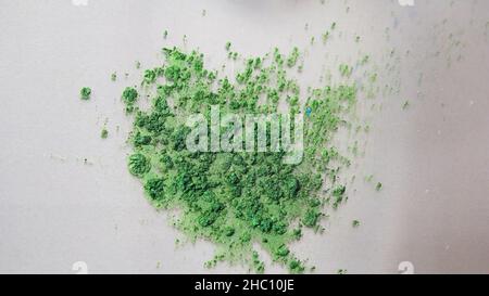 Vue de dessus des encres colorées sèches tombant dans une substance liquide blanche.Magnifique fond irisé de poudre verte, bleue et rose en fluide blanc Banque D'Images