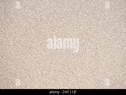 Granit beige, une surface plate de pierre naturelle avec de petites taches noires et blanches.Arrière-plan, motif, texture. Banque D'Images