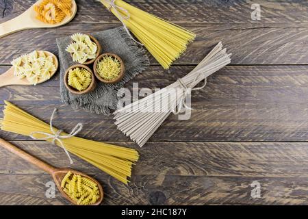 vue de dessus des cuillères et bols en bois avec des pâtes séchées sur la table du village. une copie de l'espace Banque D'Images