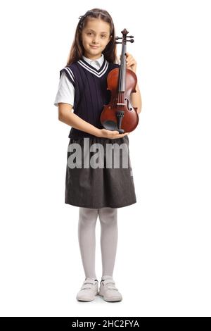 Portrait en longueur d'une écolière en uniforme tenant un violon isolé sur fond blanc Banque D'Images