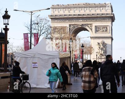 Paris, France.23rd décembre 2021.Les gens marchent près d'une tente d'essai rapide COVID-19 près de l'Arc de Triomphe à Paris, France, le 23 décembre 2021.Credit: Gao Jing/Xinhua/Alamy Live News Banque D'Images