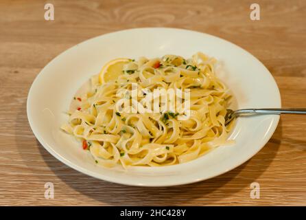 Pâtes italiennes au citron ou Tagliatelle al Limone sur une assiette blanche avec persil Banque D'Images