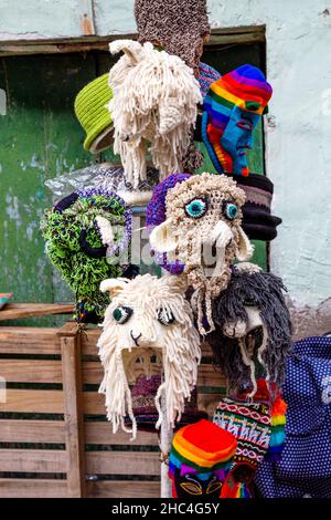 Masques et chapeaux traditionnels péruviens en tricot Waq'ollo dans une boutique de souvenirs à Cusco, Vallée Sacrée, Pérou Banque D'Images