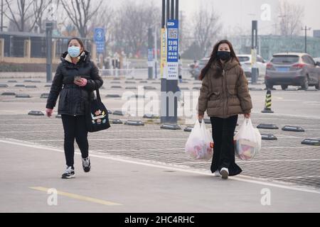 XI'AN, CHINE - 24 DÉCEMBRE 2021 - les gens emballez les nécessités quotidiennes dans un supermarché à Xi 'an, province de Shaanxi, Chine, 24 décembre 2021. Banque D'Images