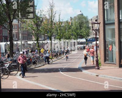 Rue centrale animée d'Amsterdam avec vélos garés Banque D'Images