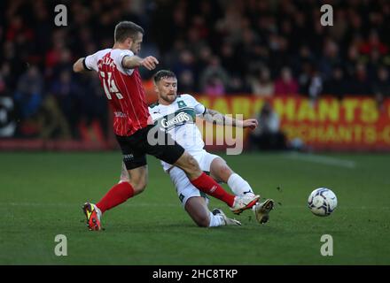 Andy Williams (à gauche) de Cheltenham Town et Dan Scarr de Plymouth Argyle se battent pour le ballon lors du match de la Sky Bet League One au stade Jonny-Rocks, Cheltenham.Date de la photo: Dimanche 26 décembre 2021. Banque D'Images