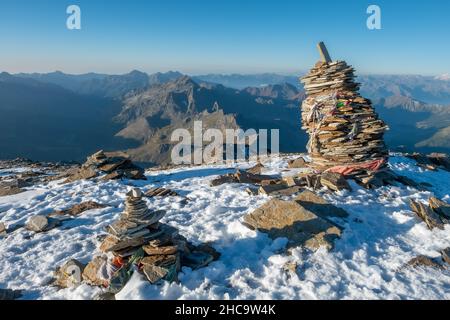 Cairn de pierre sur une crête de montagne enneigée près de Rifugio Quintino Sella al Felik Banque D'Images