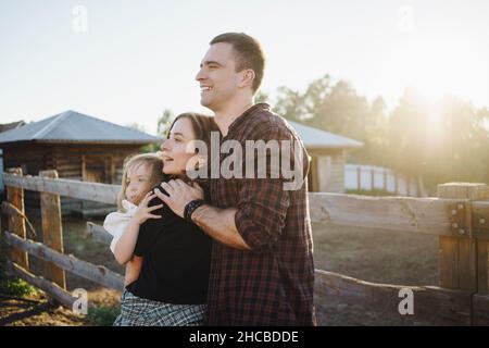 Parents souriants avec fille à la ferme Banque D'Images