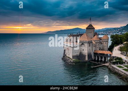 Suisse, canton de Vaud, Veytaux, vue aérienne du lac Léman et château de Chillon au coucher du soleil nuageux Banque D'Images