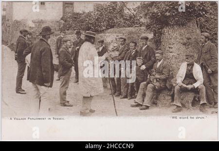 «Un Parlement de village à Sussex. NOUS avons la peine de druv': Groupe d'hommes de classe ouvrière (avec un couple d'enfants et un chien) debout dans un coin de rue sous un arbre, mettant le monde à des droits Banque D'Images