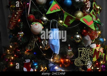 Détail d'un masque facial sur l'arbre de Noël pendant la veille de Noël à l'occasion des célébrations de Noël.Le 24 décembre 2021 au Mexique C Banque D'Images