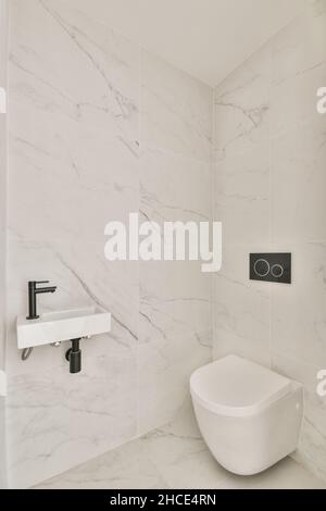 Intérieur de la salle de bains contemporaine en marbre blanc avec décoration et cuvette de toilette ronde Banque D'Images