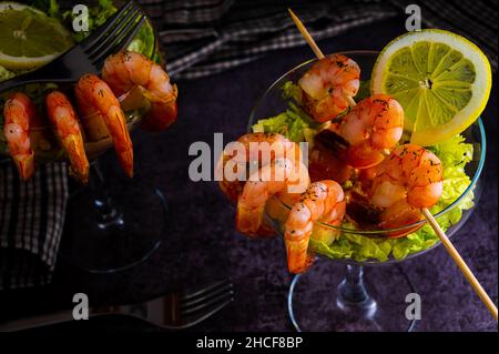 Délicieux cocktail de crevettes épicées servi dans un restaurant touristique tropical dans un verre décoré de crevettes avec une saupoudrière d'aneth, de citron et de laque Banque D'Images