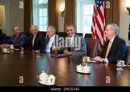 Le président des États-Unis Barack Obama serre la main avec le chef de la majorité au Sénat américain Harry Reid (démocrate du Nevada), lors d'une réunion avec les membres du Congrès sur la politique étrangère dans la salle du Cabinet de la Maison Blanche à Washington, DC, États-Unis, le jeudi 31 juillet,2014. Les États-Unis pourraient limiter le commerce des produits dérivés et les prêts à court terme avec les entreprises russes si les sanctions déjà imposées ne parviennent pas à influencer le président russe Vladimir Poutine pour mettre fin au soutien aux rebelles dans l'est de l'Ukraine.De gauche à droite : le sénateur américain Robert Menendez (démocrate du New Jersey), le sénateur américain Bob Corker (républicain de Tenn Banque D'Images