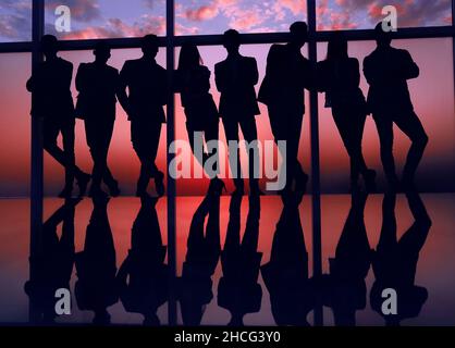Silhouette d'une équipe entreprises debout à côté de la fenêtre du bureau Banque D'Images