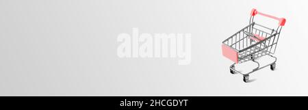 Panier rouge sur fond gris avec espace de copie.Concept d'achat de biens dans les supermarchés. Banque D'Images