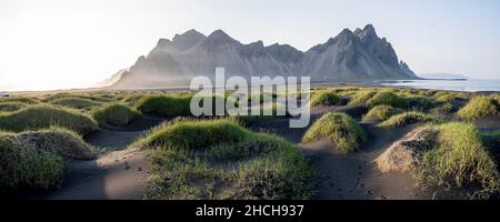 Plage de lave noire, plage de sable, dunes avec herbe sèche, montagnes Klivatindur, Eystrahorn et Kambhorn, promontoire Stokknes, chaîne de montagnes Klivatindur Banque D'Images