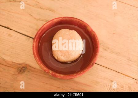 rosogolla ou rasgulla nolen gur servi sur assiette. sucré traditionnel indien bengali spongieux brun à base de fromage cottage et de jaggery. spécial hiver de Banque D'Images