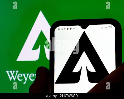 Sur cette photo, le logo de Weyerhaeuser Company est affiché sur un smartphone et en arrière-plan. Banque D'Images