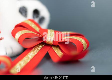 Accent sélectif sur un noeud de Noël rouge orné de paillettes dorées Banque D'Images