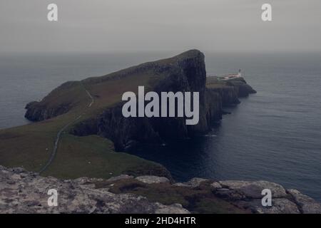 Phare de Neist point pendant un coucher de soleil brumeux, froid et humide sur l'île de Skye Banque D'Images