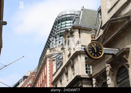 Une horloge sur le côté d'un bâtiment dans la ville de Londres Banque D'Images